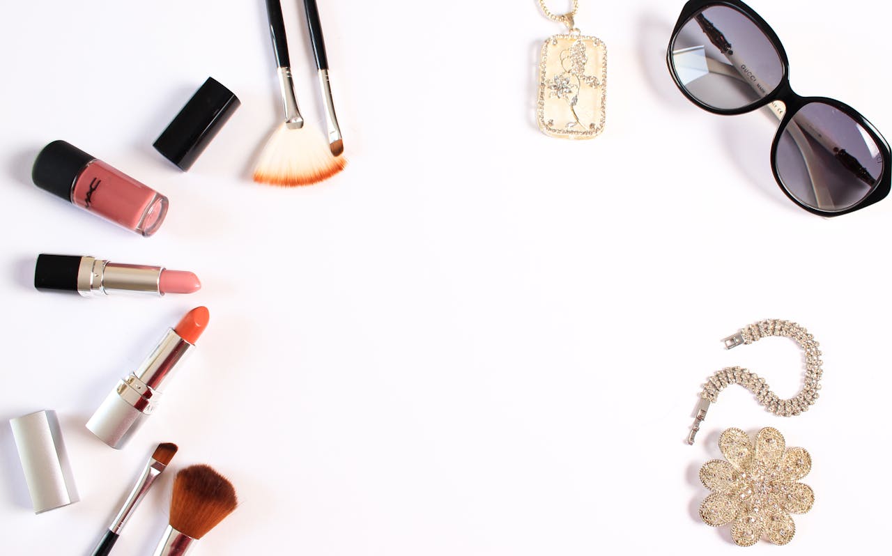 Crafting Captivating Headlines: Your awesome post title goes here Stylish flat lay of makeup brushes, lipsticks, and glam accessories on a white background.